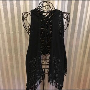 Hooded vest with fringe.